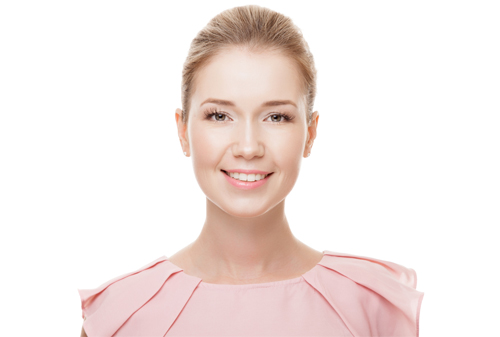 A woman in pink shirt smiling for the camera.